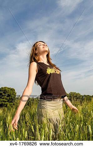 Pretty girl relaxing and enjoy in the wheat field View Large Photo Image Stock Photograph - Pretty girl relaxing and enjoy in the wheat field. Fotosearch