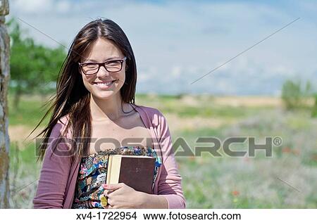 Picture - Pretty girl relaxing in the ruralscape and look at camera, Aragon, Spain. Fotosearch