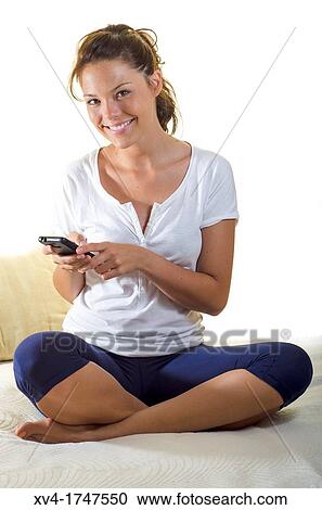 Pretty girl talk with mobile phone in the bedroom View Large Photo Image Stock Image - Pretty girl talk with mobile phone in the bedroom. Fotosearch