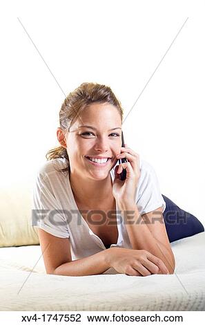 Pretty girl talk with mobile phone in the bedroom View Large Photo Image Stock Image - Pretty girl talk with mobile phone in the bedroom. Fotosearch