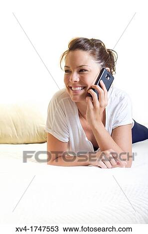 Pretty girl talk with mobile phone in the bedroom View Large Photo Image Stock Image - Pretty girl talk with mobile phone in the bedroom. Fotosearch