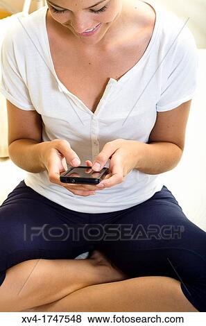 Pretty girl talk with mobile phone in the bedroom View Large Photo Image Stock Photo - Pretty girl talk with mobile phone in the bedroom. Fotosearch