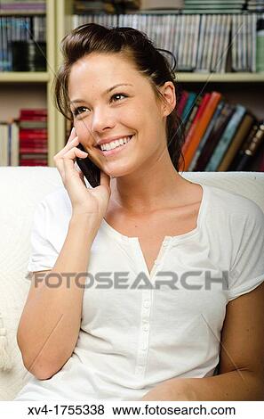 Pretty girl talk with mobile phone in the bedroom View Large Photo Image Stock Photo - Pretty girl talk with mobile phone in the bedroom. Fotosearch