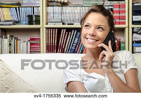 Pretty girl talk with mobile phone in the bedroom View Large Photo Image Stock Photography - Pretty girl talk with mobile phone in the bedroom. Fotosearch
