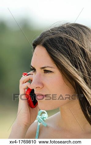 Pretty girl talks with mobile phone in the countryside View Large Photo Image Stock Image - Pretty girl talks with mobile phone in the countryside. Fotosearch