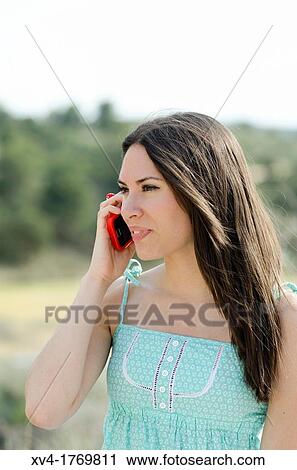 Pretty girl talks with mobile phone in the countryside View Large Photo Image Stock Image - Pretty girl talks with mobile phone in the countryside. Fotosearch