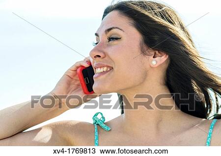 Pretty girl talks with mobile phone in the countryside View Large Photo Image Stock Image - Pretty girl talks with mobile phone in the countryside. Fotosearch