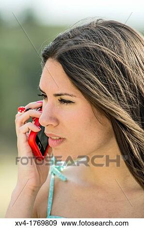 Pretty girl talks with mobile phone in the countryside View Large Photo Image Stock Photo - Pretty girl talks with mobile phone in the countryside. Fotosearch