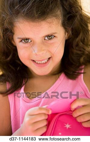 Pretty girl with a pink dress looking at the camera and smiling View Large Photo Image Stock Image - Pretty girl with a pink dress looking at the camera and smiling. Fotosearch