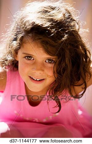 Pretty girl with a pink dress looking at the camera View Large Photo Image Stock Photo - Pretty girl with a pink dress looking at the camera. Fotosearch
