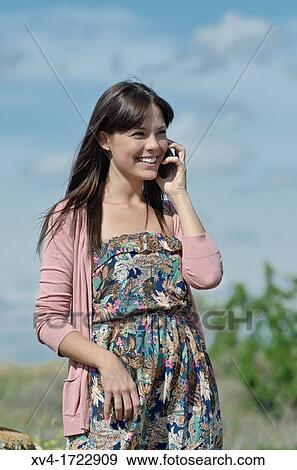 Stock Photo - Pretty girl with cell phone in outdoors. Fotosearch