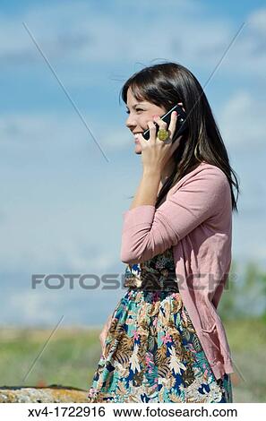 Pretty girl with cell phone in outdoors View Large Photo Image Stock Photograph - Pretty girl with cell phone in outdoors. Fotosearch
