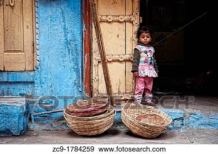 Pretty little girl standing outside the entrance to a shop Jodhpur, Rajasthan, India View Large Photo Image Stock Photo - Pretty little girl standing outside the entrance to a shop Jodhpur, Rajasthan, India. Fotosearch