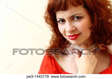 Stock Photo - Pretty redhead young woman portrait indoors. Fotosearch