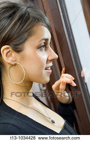 Pretty woman is expecting someone View Large Photo Image Stock Photo - Pretty woman is expecting someone. Fotosearch