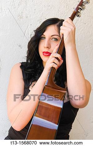 Pretty woman portrait with a guitar View Large Photo Image Stock Image - Pretty woman portrait with a guitar. Fotosearch