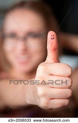 Pretty woman with smiles on thumb giving thumbs up. View Large Photo Image Stock Image - Pretty woman with smiles on thumb giving thumbs up.. Fotosearch