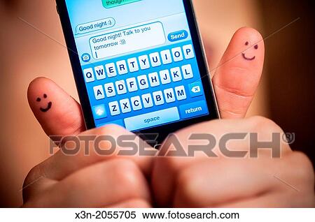 Pretty woman with smiles on thumbs texting good night with smartphone. View Large Photo Image Stock Photography - Pretty woman with smiles on thumbs texting good night with smartphone.. Fotosearch