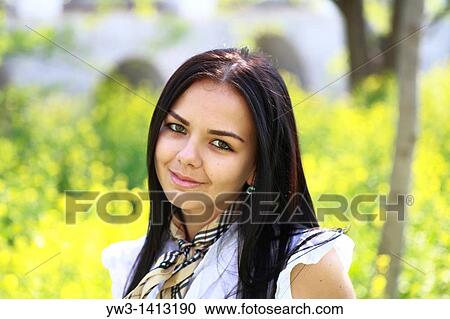 Pretty young 20-25 years woman in the garden among grass flowers View Large Photo Image Stock Image - Pretty young 20-25 years woman in the garden among grass flowers. Fotosearch
