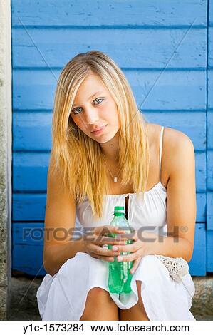 Pretty young blonde with a bottle of water in hands View Large Photo Image Picture - Pretty young blonde with a bottle of water in hands. Fotosearch