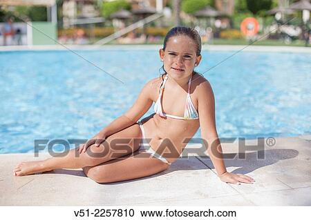 Stock Image - Pretty young girl in swimming pool. Fotosearch