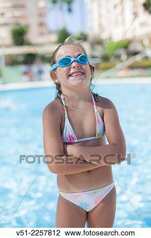 Pretty young girl in swimming pool laughing with Swim Goggles View Large Photo Image Stock Image - Pretty young girl in swimming pool laughing with Swim Goggles. Fotosearch
