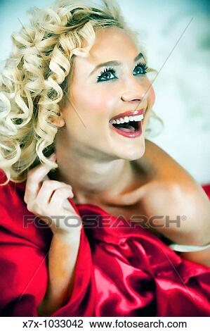 Stock Image - Pretty, young, sexy blonde girl smiling. Fotosearch