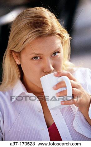 Pretty young woman drinking coffee View Large Photo Image Stock Image - Pretty young woman drinking coffee. Fotosearch
