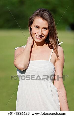 Pretty young woman in park smiling at camera View Large Photo Image Stock Photograph - Pretty young woman in park smiling at camera. Fotosearch
