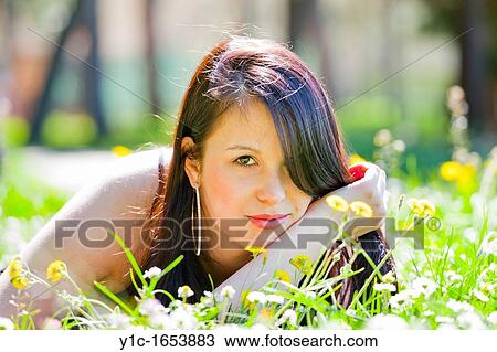 Pretty young woman in the grass View Large Photo Image Stock Image - Pretty young woman in the grass. Fotosearch