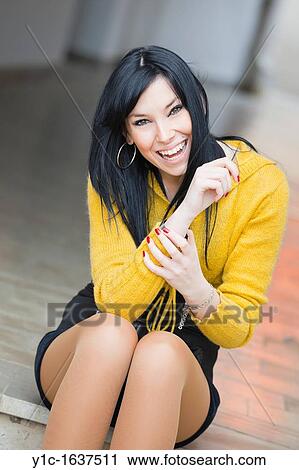 Stock Image - Pretty young woman is happy. Fotosearch