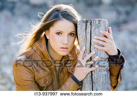 Pretty young woman is posing outdoors View Large Photo Image Stock Photo - Pretty young woman is posing outdoors. Fotosearch