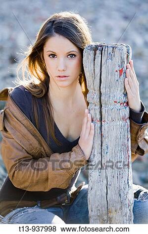 Stock Photo - Pretty young woman is posing outdoors. Fotosearch