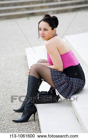 Pretty young woman is sitting on steps View Large Photo Image Stock Image - Pretty young woman is sitting on steps. Fotosearch