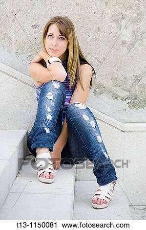 Pretty young woman is sitting on staircase View Large Photo Image Stock Image - Pretty young woman is sitting on staircase. Fotosearch