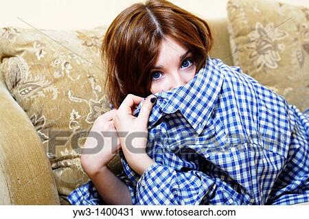 Pretty young woman lying on sofa, looking at camera View Large Photo Image Stock Image - Pretty young woman lying on sofa, looking at camera. Fotosearch