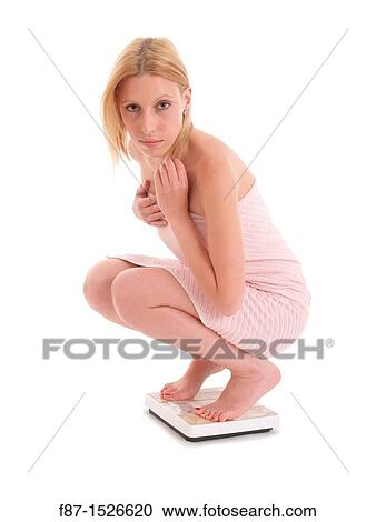 Pretty young woman on scale, isolated on white background View Large Photo Image Stock Image - Pretty young woman on scale, isolated on white background. Fotosearch
