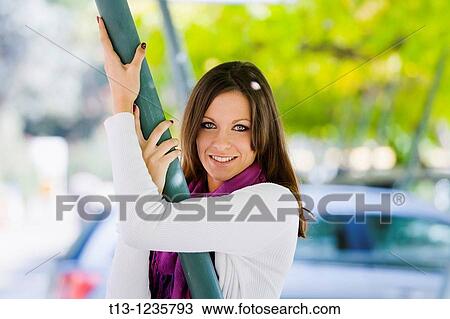 Pretty young woman portrait on a parking place View Large Photo Image Stock Image - Pretty young woman portrait on a parking place. Fotosearch