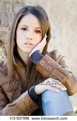 Stock Photograph - Pretty young woman portrait outdoors. Fotosearch