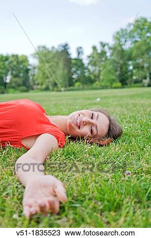 Pretty young woman relaxing in park View Large Photo Image Stock Image - Pretty young woman relaxing in park. Fotosearch