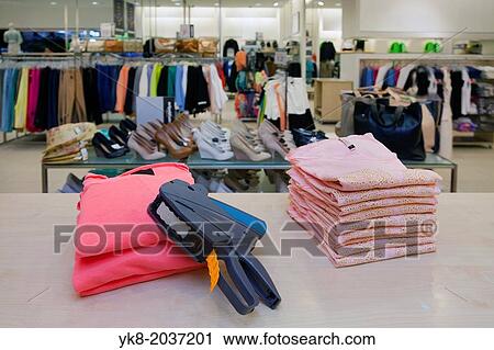 Pricing, store, desk. Price gun on folded clothes of counter in retail shop interior. View Large Photo Image Stock Image - Pricing, store, desk. Price gun on folded clothes of counter in retail shop interior.. Fotosearch