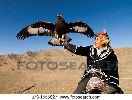 Stock Photo - Pride! A Kazakh eagle hunter with his Golden Eagle.. Fotosearch