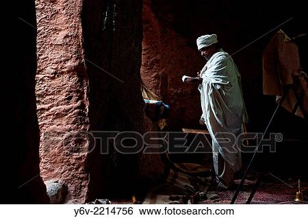 Priest reading the Bible during a mass in a orthodox church i. e. Bet Giyorgis church. Lalibela, Ethiopia. View Large Photo Image Stock Photograph - Priest reading the Bible during a mass in a orthodox church i. e. Bet Giyorgis church. Lalibela, Ethiopia.. Fotosearch