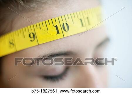 Primer plano de chica adolescente con cinta m? trica rodeando la frente, Closeup of teenage girl with tape measure round the front, View Large Photo Image Stock Image - Primer plano de chica adolescente con cinta m? trica rodeando la frente, Closeup of teenage girl with tape measure round the front,. Fotosearch