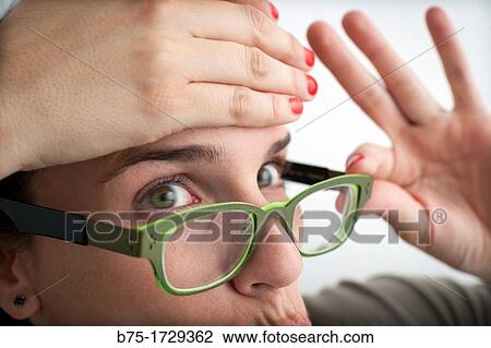 primer plano de mujer joven con gafas observando y con aptitud de preocupacion, close-up of young woman with glasses watching and fitness concern View Large Photo Image Stock Image - primer plano de mujer joven con gafas observando y con aptitud de preocupacion, close-up of young woman with glasses watching and fitness concern. Fotosearch