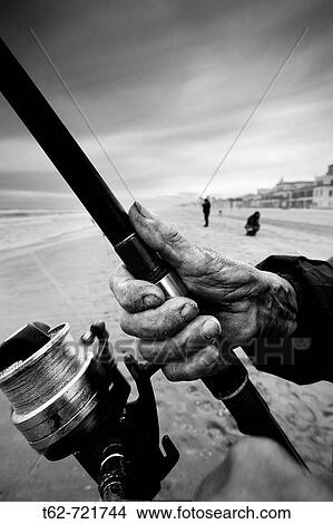 Primer plano manos de pescador de caa. En la Playa. Costa Dorada (Tarragona). Spain. View Large Photo Image Picture - Primer plano manos de pescador de caa. En la Playa. Costa Dorada (Tarragona). Spain.. Fotosearch
