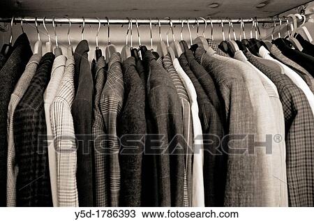 Stock Image - private men's wardrobe full of men's jackets, Sepia image. Fotosearch