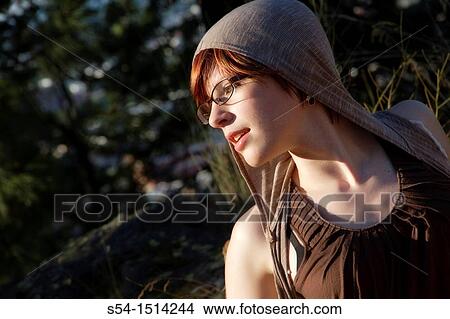 Profile of a young woman outdoors. View Large Photo Image Picture - Profile of a young woman outdoors.. Fotosearch