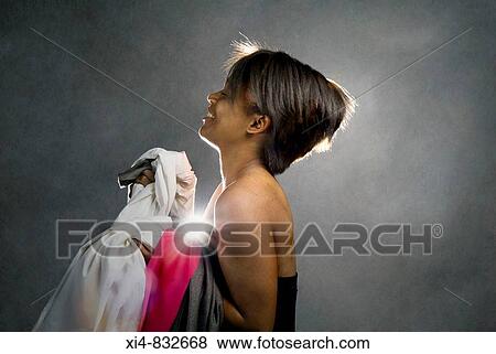 Profile of african-american young female holding bed linens and clothes Back light and hair halo View Large Photo Image Stock Photo - Profile of african-american young female holding bed linens and clothes Back light and hair halo. Fotosearch