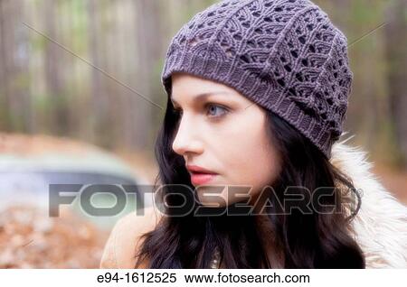 Profile portrait of a 20 year old brunettte woman wearing a knit cap looking away from the the camera outdoors. View Large Photo Image Stock Photography - Profile portrait of a 20 year old brunettte woman wearing a knit cap looking away from the the camera outdoors.. Fotosearch